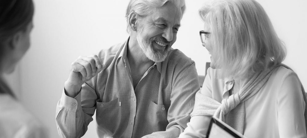 Careers 1 Older couple discussing real estate transaction.